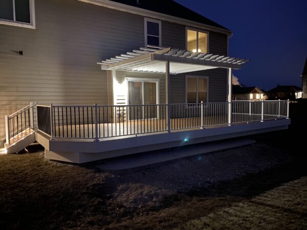 spacious-residential-deck-with-white-pergola-attached-on-the-gray-house-with-sliding-glass-door-in-oak-creek-wi
